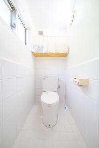 a white bathroom with a toilet and a window at ふんわり in Miyakojima +25 photos