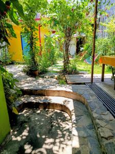 a garden with a stone path and trees and a building at Posada "Jardin Huasteca Xilitla" in Xilitla