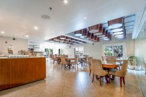 a kitchen and dining room with tables and chairs at De Amour - A Dreamy Getaway in Anjuna in Anjuna