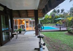 a camera on a tripod in front of a house at Villa Serenity welcomes you in Pacific Harbour +20 photos