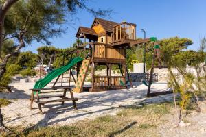 a playground with a tree house and a slide at Mobile Homes Krk Silo in Šilo