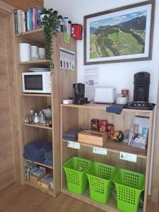 a book shelf with baskets and a microwave at Sauschneidhof - Radstadt in Radstadt
