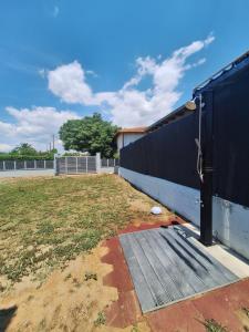 a fence with a wooden ramp next to a yard at VILLA HAWAii in Nea Moudania +3 photos