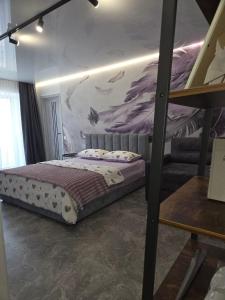 a bedroom with a bunk bed with a mural on the wall at Апартаменты возле отеля Украина in Chernihiv