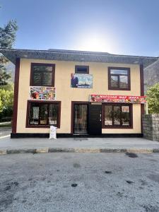 a building with a sign in front of it at Sharshara-Darvoz in Sangovy