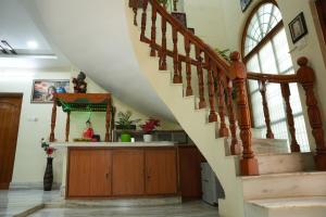 a staircase in a home with a kitchen and a stair case at Manavididillu 4BHK DUPLEX VILLA in Rājahmundry