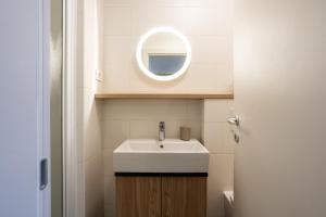 a bathroom with a sink and a mirror at Casa Riccobon 5 in Koper