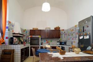 a kitchen with a bunch of tiles on the wall at Casa Janca Pizzo in Pizzo