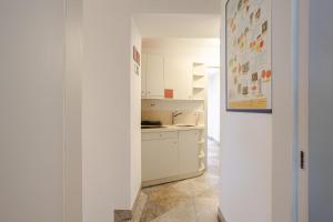 a kitchen with white cabinets and a counter top at Casa Riccobon 5 in Koper
