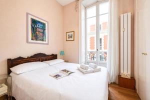 a bedroom with a white bed with towels on it at Regina - Duplex in Heart of Menton - Happy Rentals in Menton