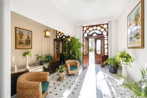a lobby with wicker chairs and potted plants at Regina - Duplex in Heart of Menton - Happy Rentals in Menton