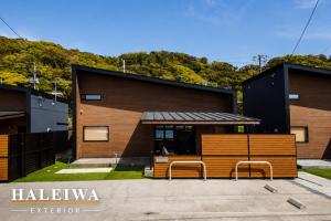 a building with two benches in front of it at 千葉地域ランキング1位獲得の贅沢な貸別荘全4棟 in Hota