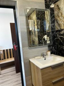 a bathroom with a sink and a mirror at Casa Acati Venus in Venus