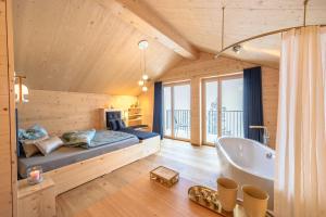 a bedroom with a bed and a bath tub at Berglodge37 in Altdorf +33 photos