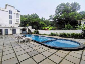 a swimming pool in the yard of a house at Goa Courtyard in Arpora