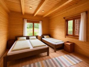 a bedroom with two beds and a window at Égéspatak Vendégház in Ghiduţ