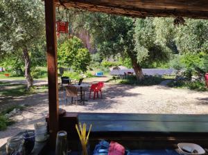 a view of a yard with a table and chairs at Gjipe eco campground 2 in Ilias +10 photos