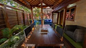 a wooden table on the back of a house at Mango Garden in Gili Islands