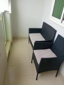 two chairs and a table in a room at Lois Beach Resort in Nyanyanu