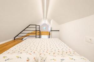 a bedroom with a bed and a staircase at Dovce Apartments in Rakek