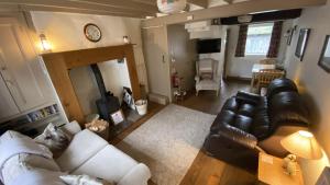 a living room with a couch and a table at Sunnyside Cottage in Sedbergh +5 photos