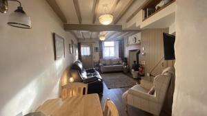 a living room with a couch and a table at Sunnyside Cottage in Sedbergh