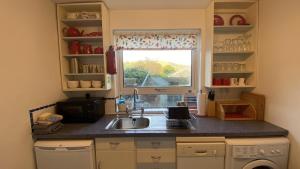 a kitchen with a sink and a window at Sunnyside Cottage in Sedbergh