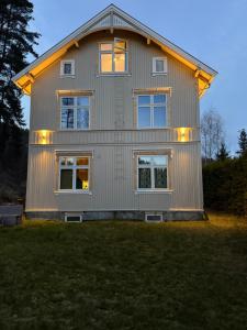 a house with lights on the side of it at Central Studio apartment in Notodden