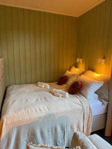 a bed with towels on it in a room at Central Studio apartment in Notodden