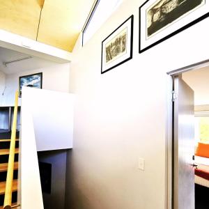 a staircase in a house with two pictures on the wall at Fusion Townhouse-North Hobart in West Hobart