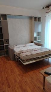 a large bed in a room with a wooden floor at CASA AZZURRA Domodossola FREE PARKING in Domodossola
