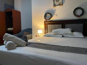 a bedroom with a large bed with wreaths on the wall at Lois Beach Resort in Nyanyanu +27 photos