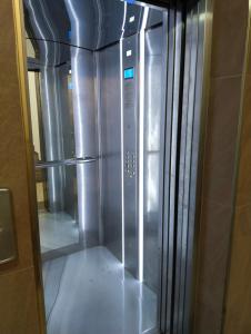 an empty refrigerator in a building with its door open at Comfy Home in Pomorie