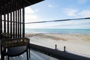 a balcony with a chair and a view of the beach at Ustyurt boutique hotel in Aktau