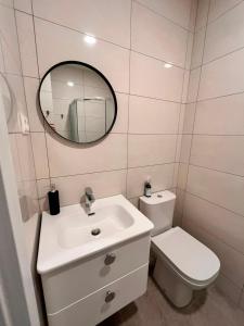 a bathroom with a sink and a toilet and a mirror at Pakalnės sodyba in Skverbai +23 photos