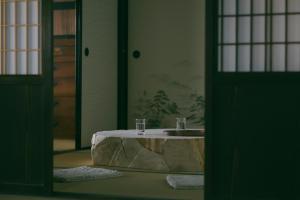 a bathroom with a sink in the middle of a room at 暇家 kaya in Yosano