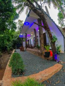 a villa with a view of a house with purple lights at Lake View Eco Lodge in Dambulla
