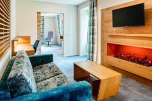 a living room with a couch and a fireplace at Hotel Schwan & Post in Bad Neustadt an der Saale