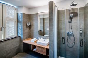 a bathroom with a sink and a shower at Hotel Schwan & Post in Bad Neustadt an der Saale +16 photos