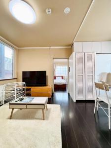 a living room with a tv and a coffee table at 北海道大学ENYA-n17 in Sapporo