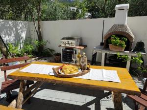a picnic table with a basket of food and a oven at Pansion Ivana studios in Baška Voda