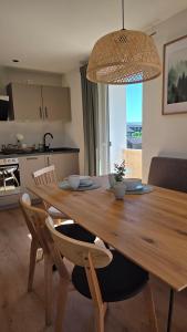 a wooden table with chairs and a dining room at Bachwagnerhof in Staudach-Egerndach