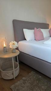 a bedroom with a bed with a table and a candle at Bachwagnerhof in Staudach-Egerndach +13 photos