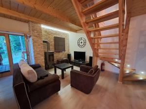 a living room with two couches and a tv at Przystanek Jezioro - Kaszuby in Studzienice