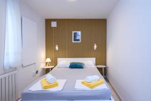 a bedroom with a bed with towels on it at Villa Bazilika in Sečovlje