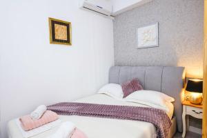 a small bedroom with a bed and a table at Villa Bazilika in Sečovlje