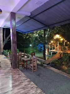 a patio with a table and chairs under a canopy at Lake View Eco Lodge in Dambulla