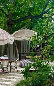 a patio with tables and chairs and umbrellas at Hotel Vanilla in Timişoara