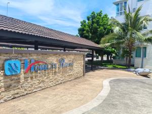 a building with a sign that reads no one left behind at Homelite Resort in Miri