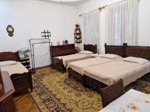 a bedroom with two beds and a cross on the wall at Guest House Guro kobuleti in Kobuleti